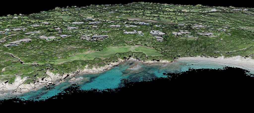 Colourised aerial LiDAR point cloud of a rocky coastline, with the shallow seabed visible through the water