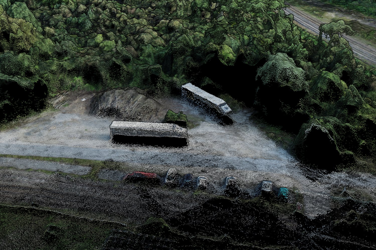 Close-up of the photogrammetric point cloud: two trucks in a yard and parked cars along a road